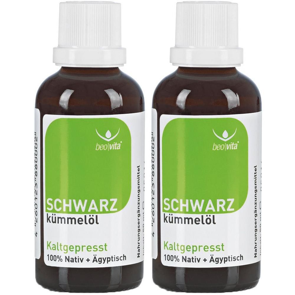 Zwei braune Glasflaschen mit weißem Schraubverschluss, gefüllt mit schwarzkümmelöl. Grüne Etiketten mit Produktinformationen.