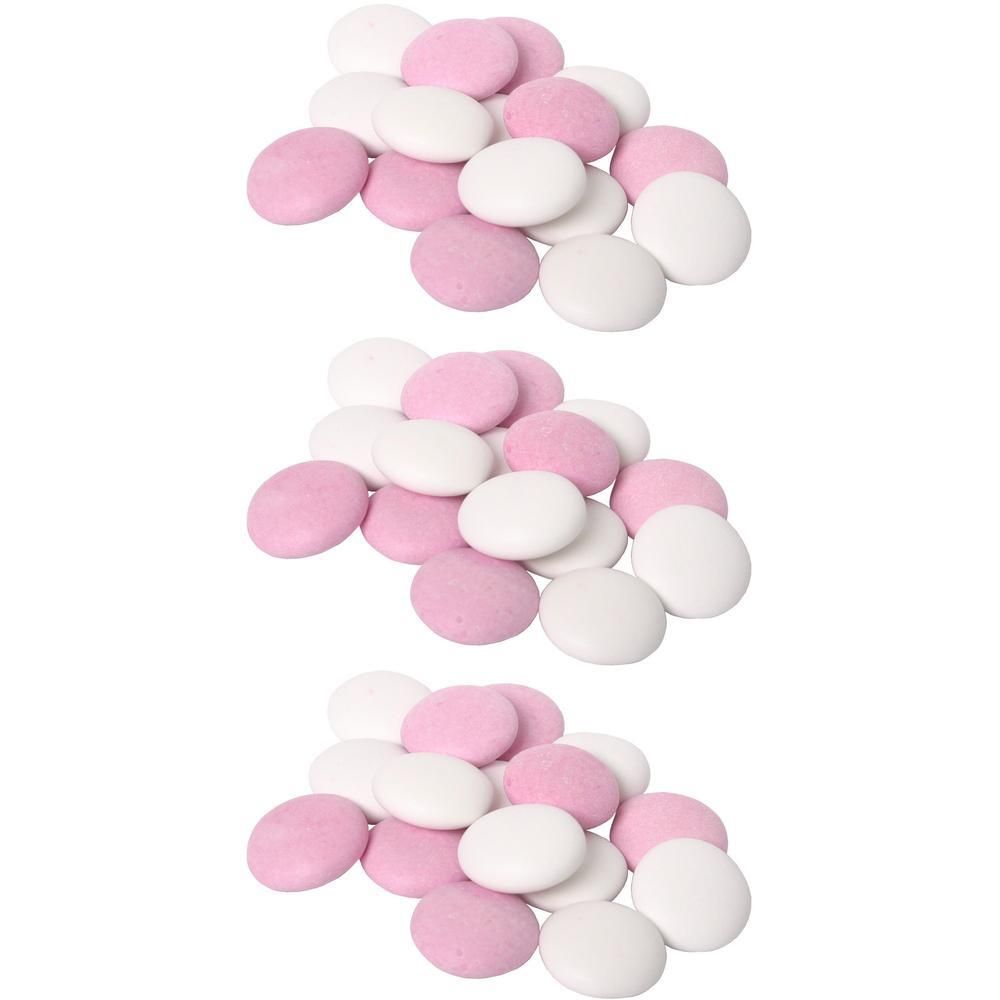 Weiße und rosa Schokolinsen, flach und rund.