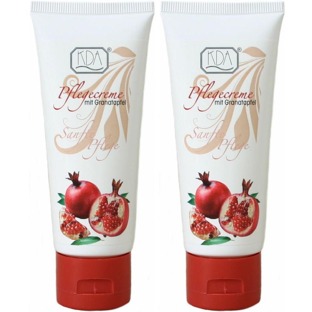 Zwei weiße Tuben KDA Pflegecreme mit Granatapfelmotiv und rotem Deckel.