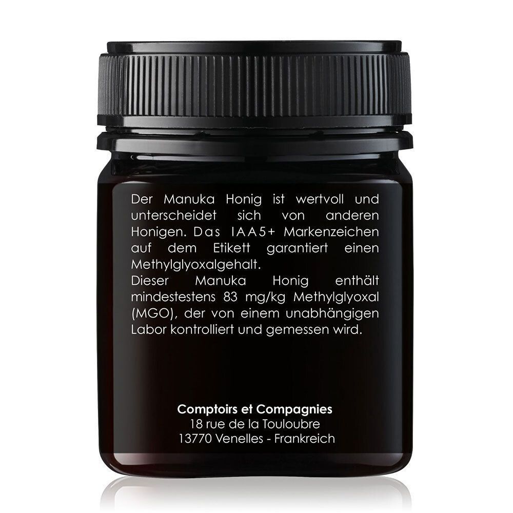 Rückseite eines Glases Manuka Honig mit detaillierter Produktbeschreibung und Herstellerinformationen.