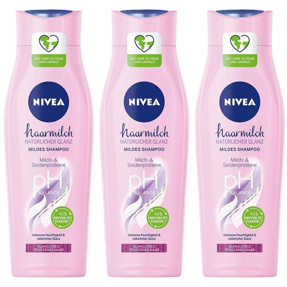 Drei NIVEA Haarmilch Pflegeshampoo Flaschen in Rosa mit blauen Verschlüssen. Mit pH Balance und 96% recycelbarer Flasche.