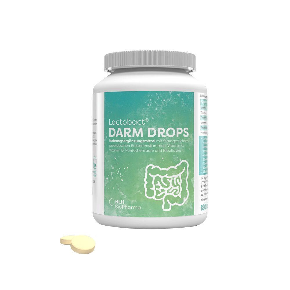 Ein weißer Behälter mit Lactobact Darm Drops und zwei Tabletten davor, mit Etikett, das ein Darmdiagramm zeigt.
