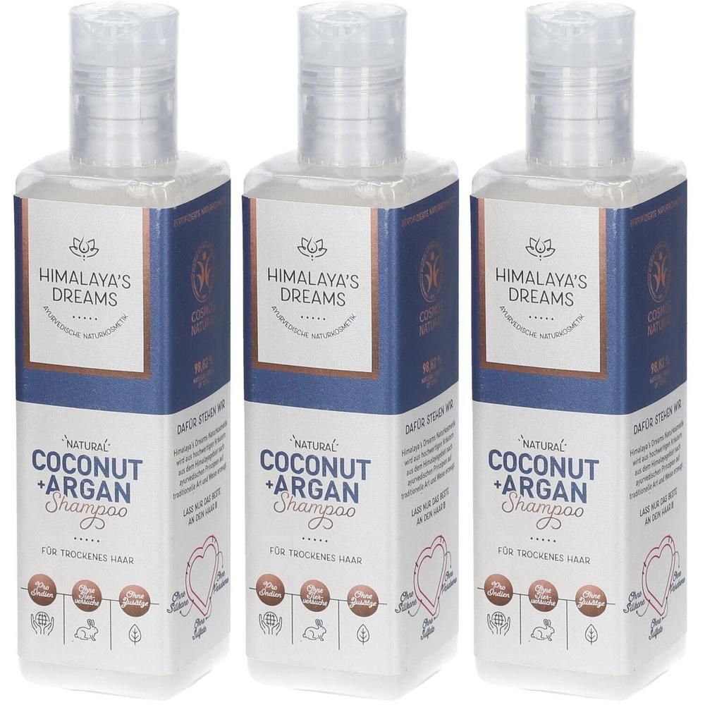 Drei Flaschen Himalaya's Dreams Natural Coconut + Argan Shampoo für trockenes Haar. Klare Flaschen mit blauen Etiketten.