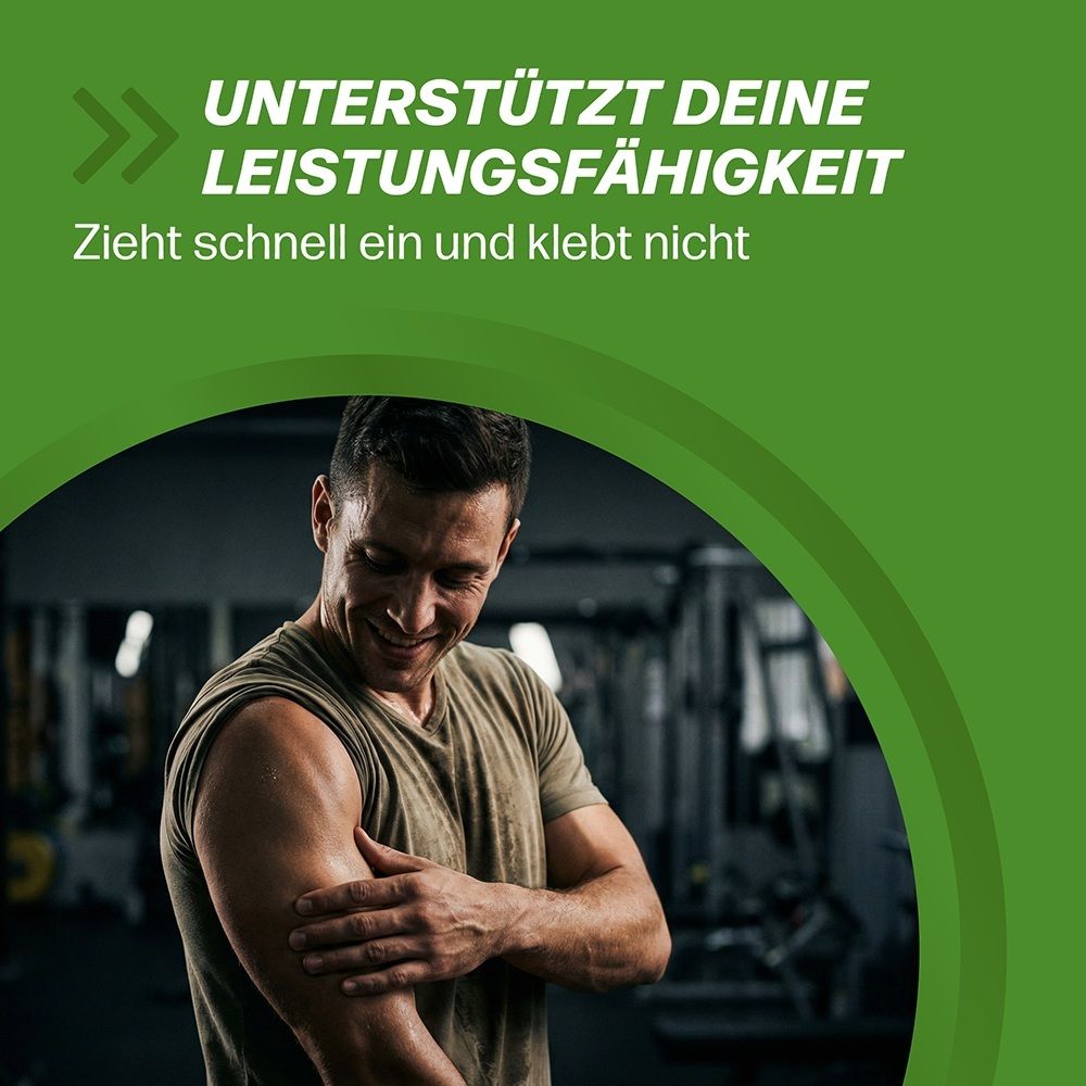 Mann reibt sich den Bizeps in einem Fitnessstudio. Text: Unterstützt deine Leistungsfähigkeit.