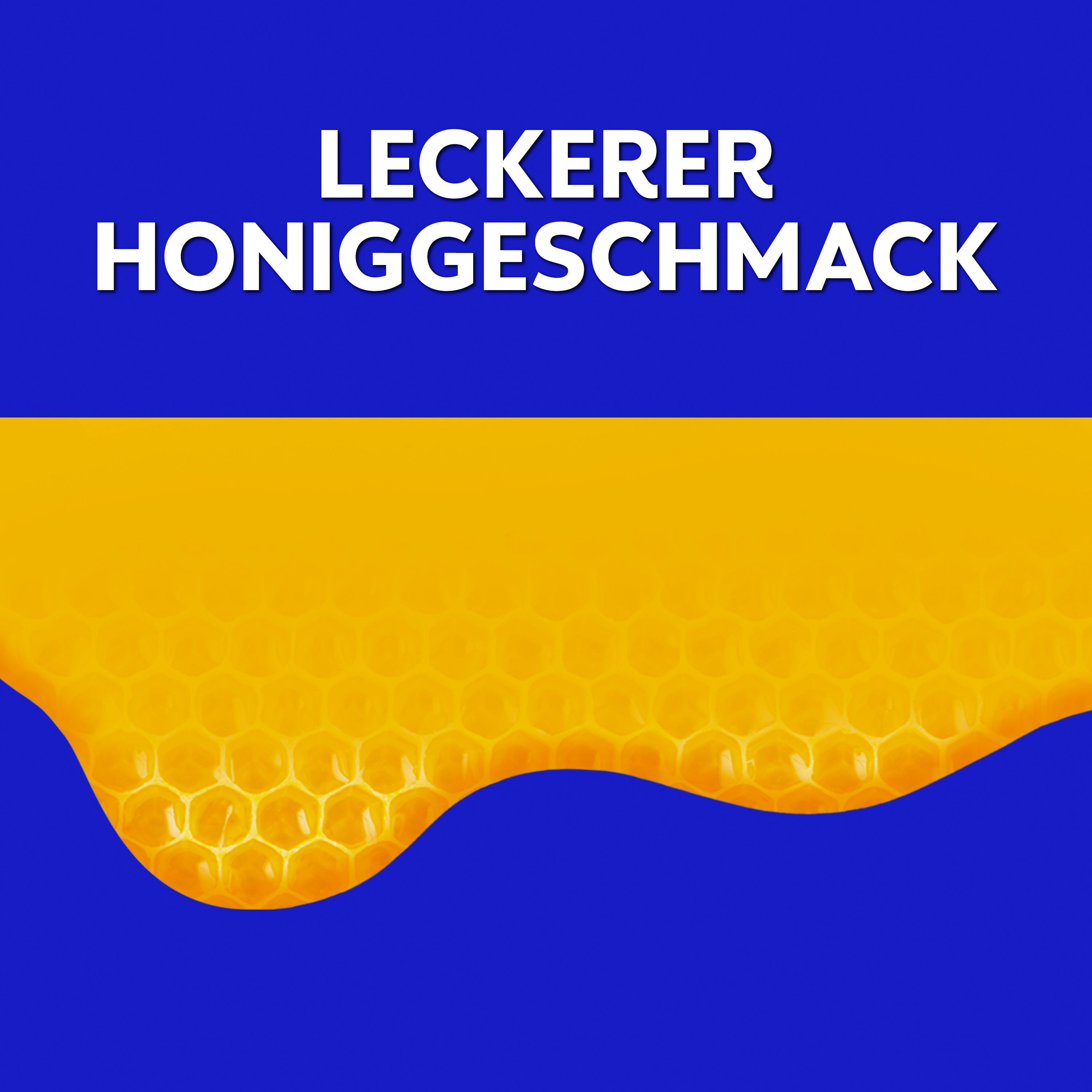 Nahaufnahme von flüssigem Honig über einem Bienenwabenmuster.