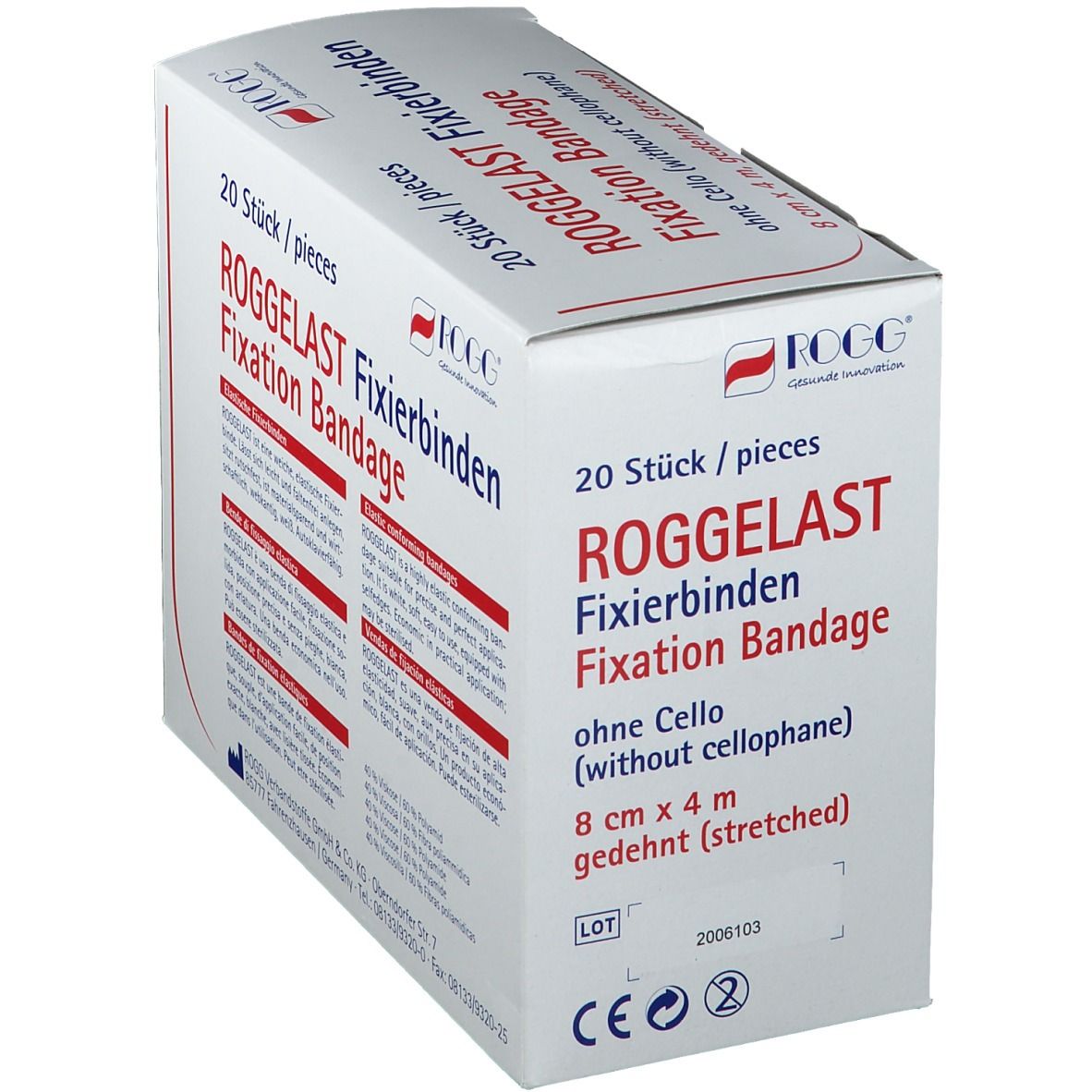 ROGGELAST Fixierbinden-Verpackung. 20 Stück. 8 cm x 4 m. Aufschrift: weich, elastisch, rutschfest. Weißer Karton, schräg gestellt, mit Lot-Nummer.