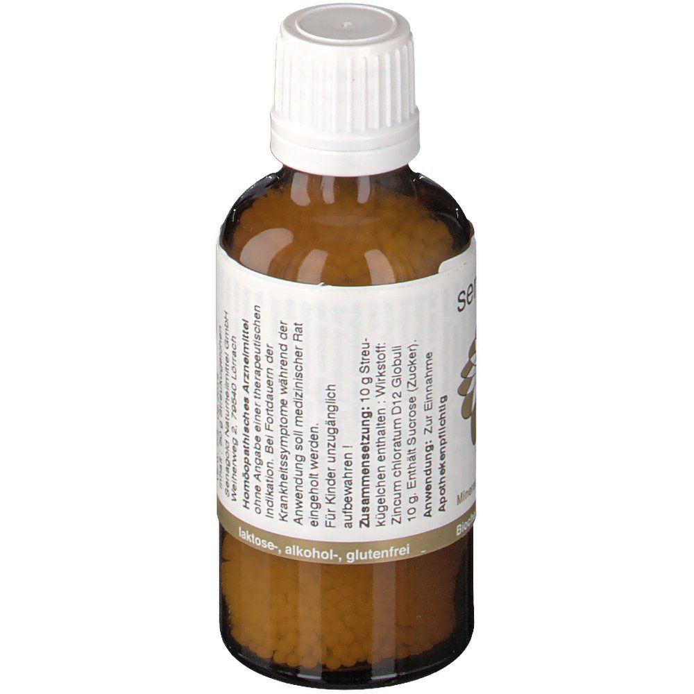 Braune Glasflasche mit weißem Deckel. Etikett mit Zusammensetzung: Zincum chloratum D12 Globuli, Sucrose. Apothekenpflichtig. Frei von Laktose, Alkohol, Gluten.