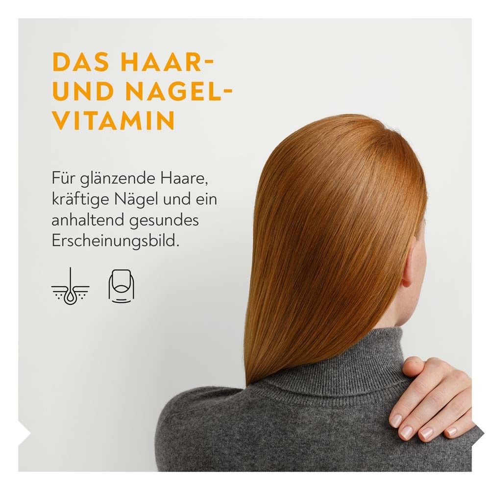 Rückansicht einer Frau mit langen, roten Haaren. Text: Das Haar- und Nagel-Vitamin. Für glänzende Haare, kräftige Nägel.