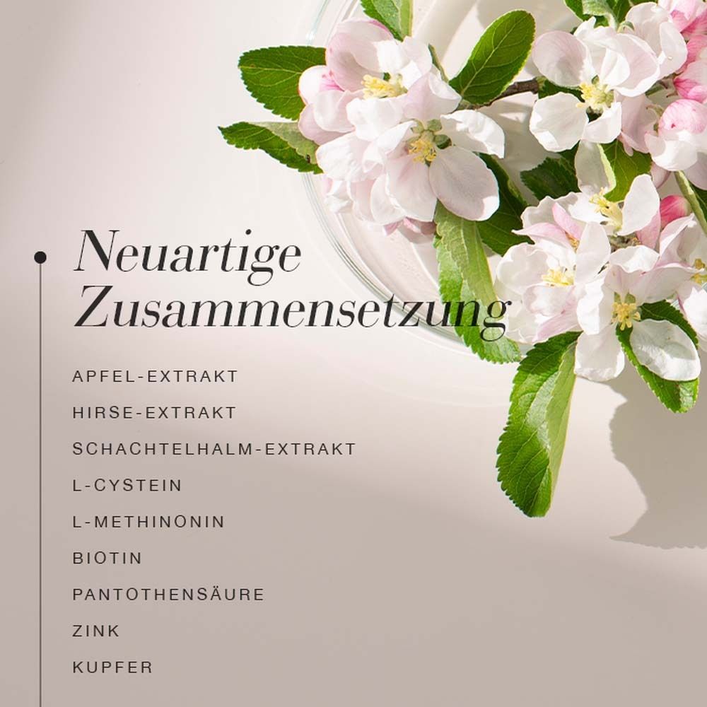 Blütenzweig mit Text: Neuartige Zusammensetzung. Inhaltsstoffe: Apfel-Extrakt, Hirse-Extrakt, Schachtelhalm-Extrakt, L-Cystein, L-Methionin, Biotin, Pantothensäure, Zink, Kupfer.