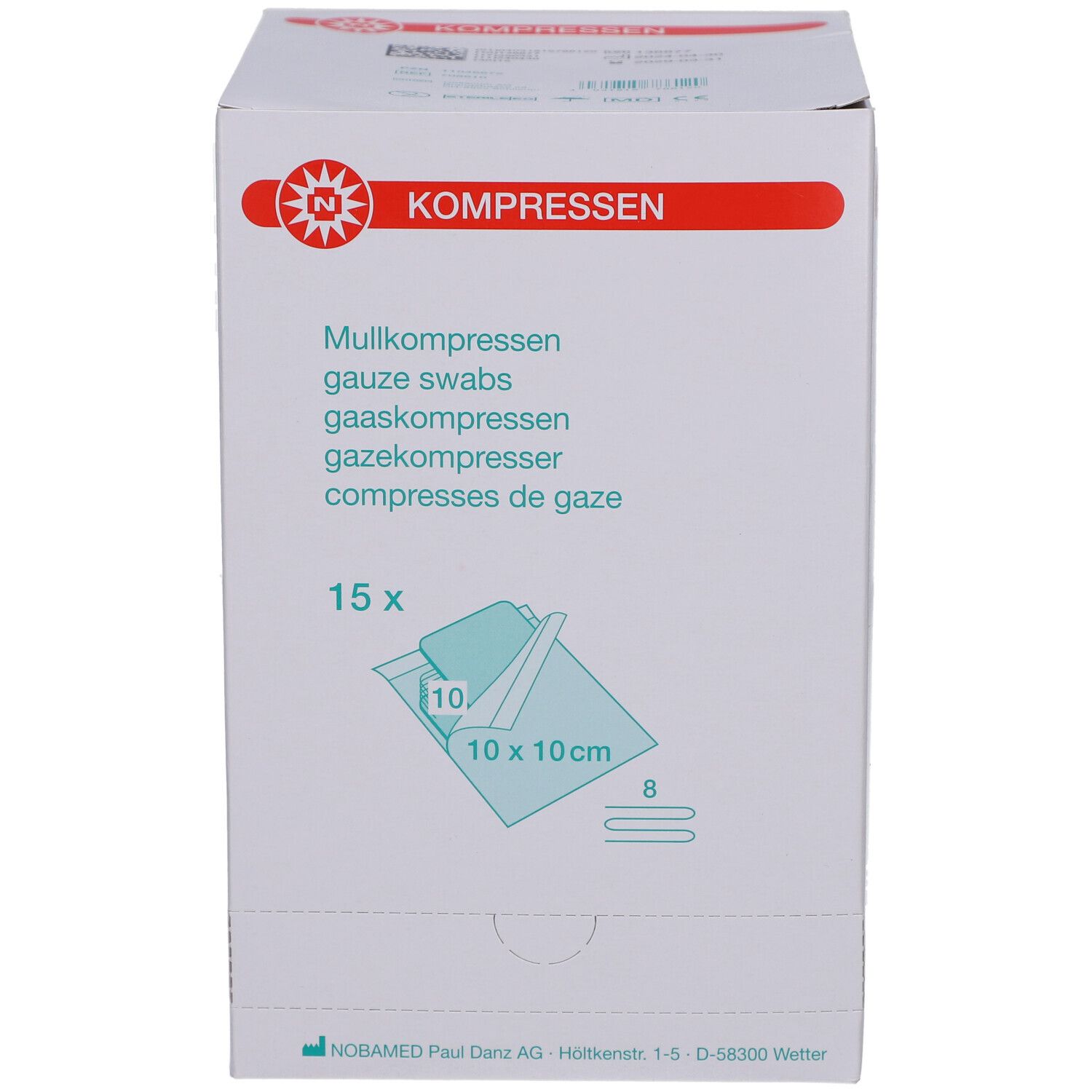 Weißer Karton mit roter Beschriftung. Aufdruck: Mullkompressen, 15 Stück, 10x10 cm. Marke: NOBAMED.