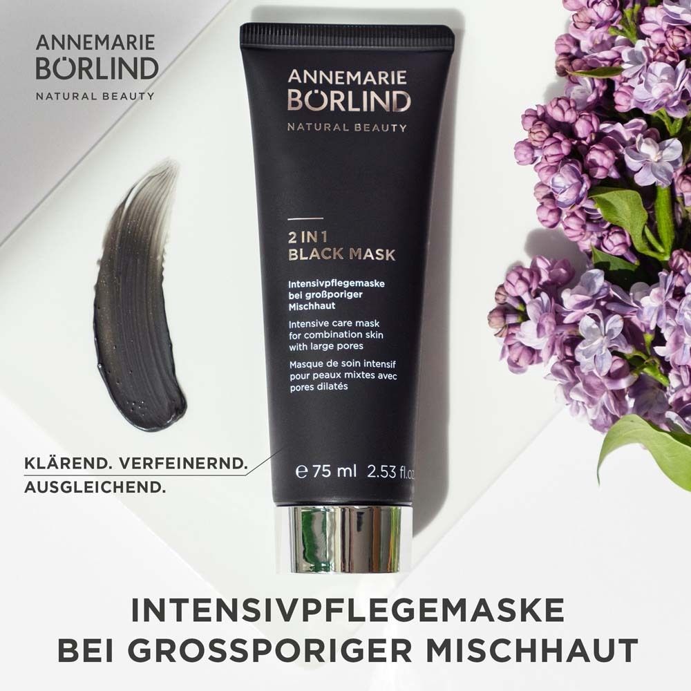 Schwarze Tube mit Produktaufschrift. Marke: ANNEMARIE BÖRLIND. Produkt: 2 IN 1 BLACK MASK. Text und Blüten.