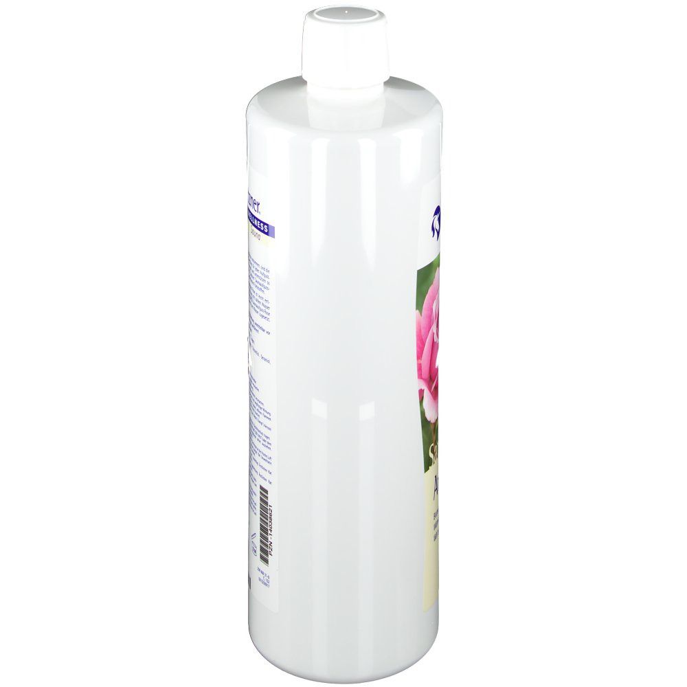 Weiße Flasche mit weißem Deckel. Etikett mit Text und Bild einer Rose. Blickwinkel von der Seite.