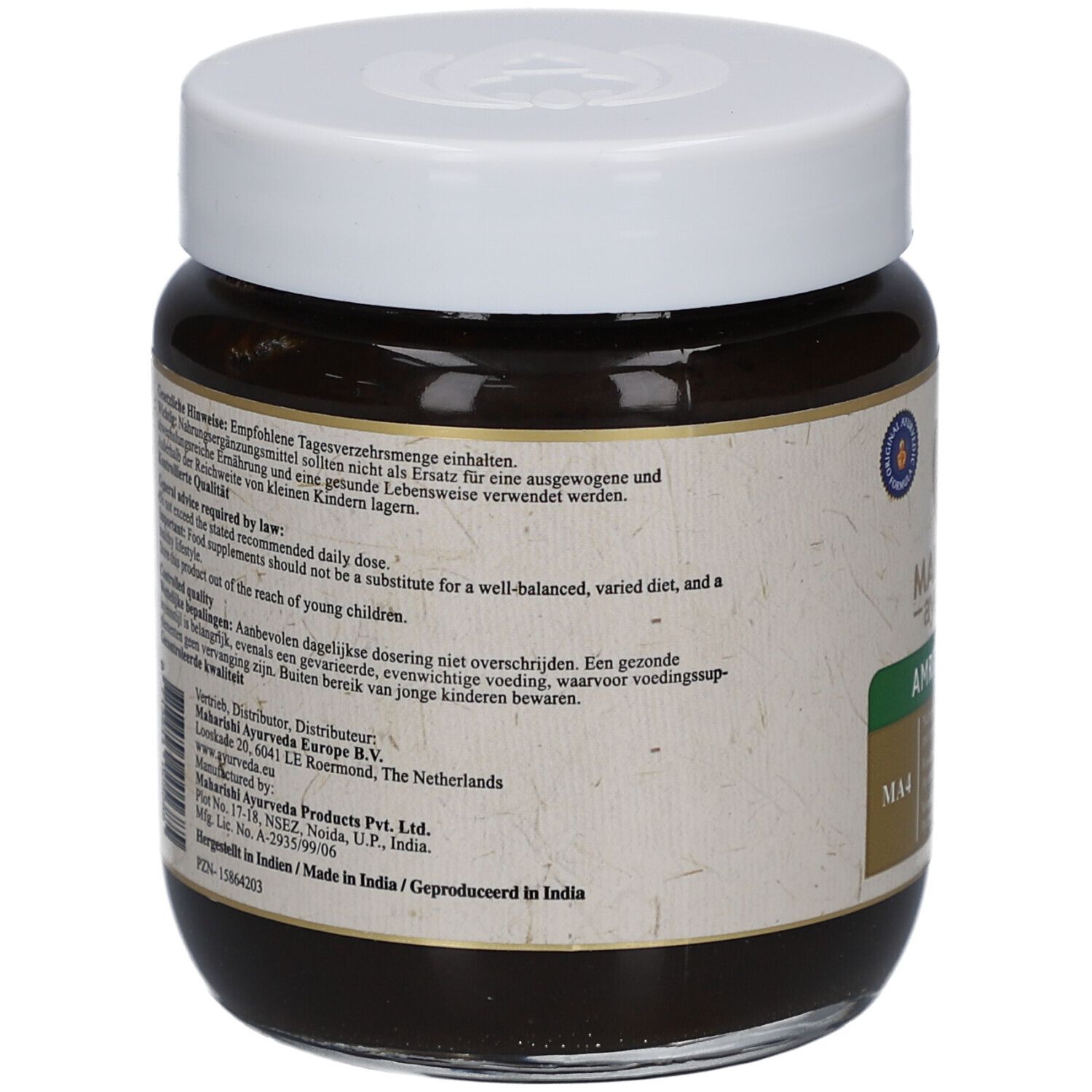 Rückansicht des Glases mit brauner Paste und weißem Deckel. Etikett mit Text und Informationen. Siegel.