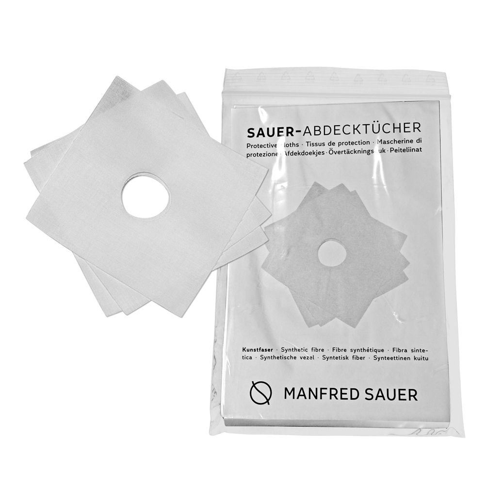 MANFRED SAUER Abdecktücher für Urinal-Kondome, 24 mm. Mehrere weiße Tücher mit Loch in der Mitte, neben der Verpackung.
