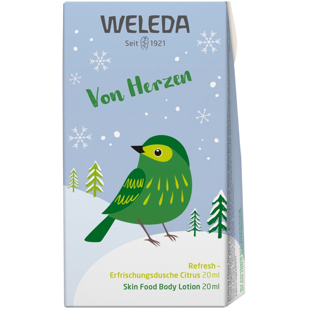 Hellblaue Geschenkbox mit Vogelmotiv, Schneeflocken und Schriftzug WELEDA. Enthält Refresh Erfrischungsdusche und Skin Food Body Lotion.