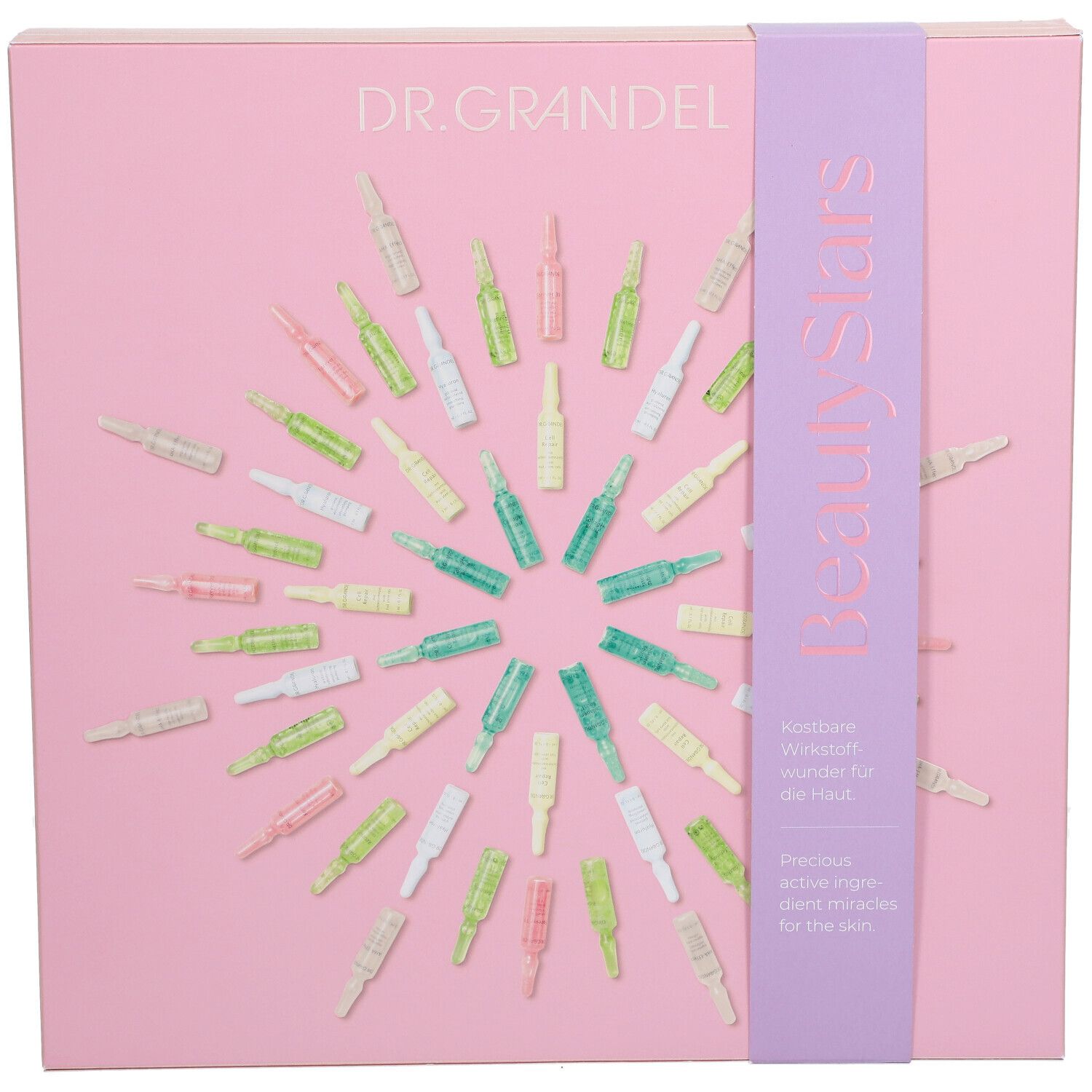 Rosa Geschenkbox mit Ampullen. Aufschrift DR. GRANDEL und BeautyStars. Lila Band mit Text. Ampullen in verschiedenen Farben angeordnet.
