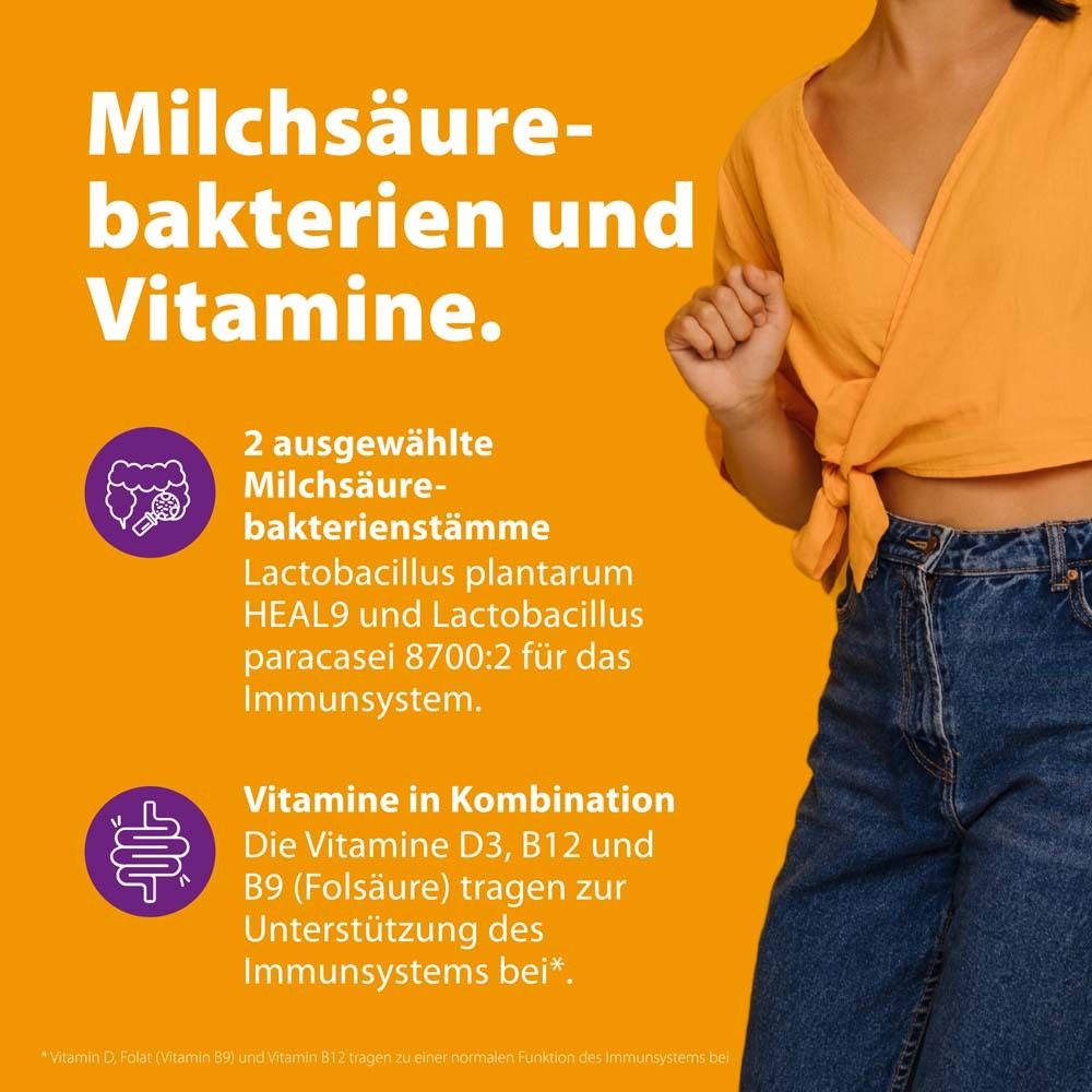 Text: Milchsäurebakterien und Vitamine. 2 Milchsäurebakterienstämme. Vitamine D3, B12, B9 (Folsäure) zur Unterstützung des Immunsystems.