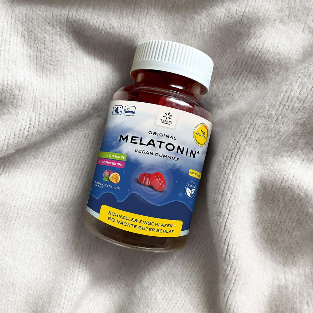 Flasche mit roten Gummibärchen auf einem grauen Stoff. Aufschrift: Original Melatonin+ Vegan Gummies.