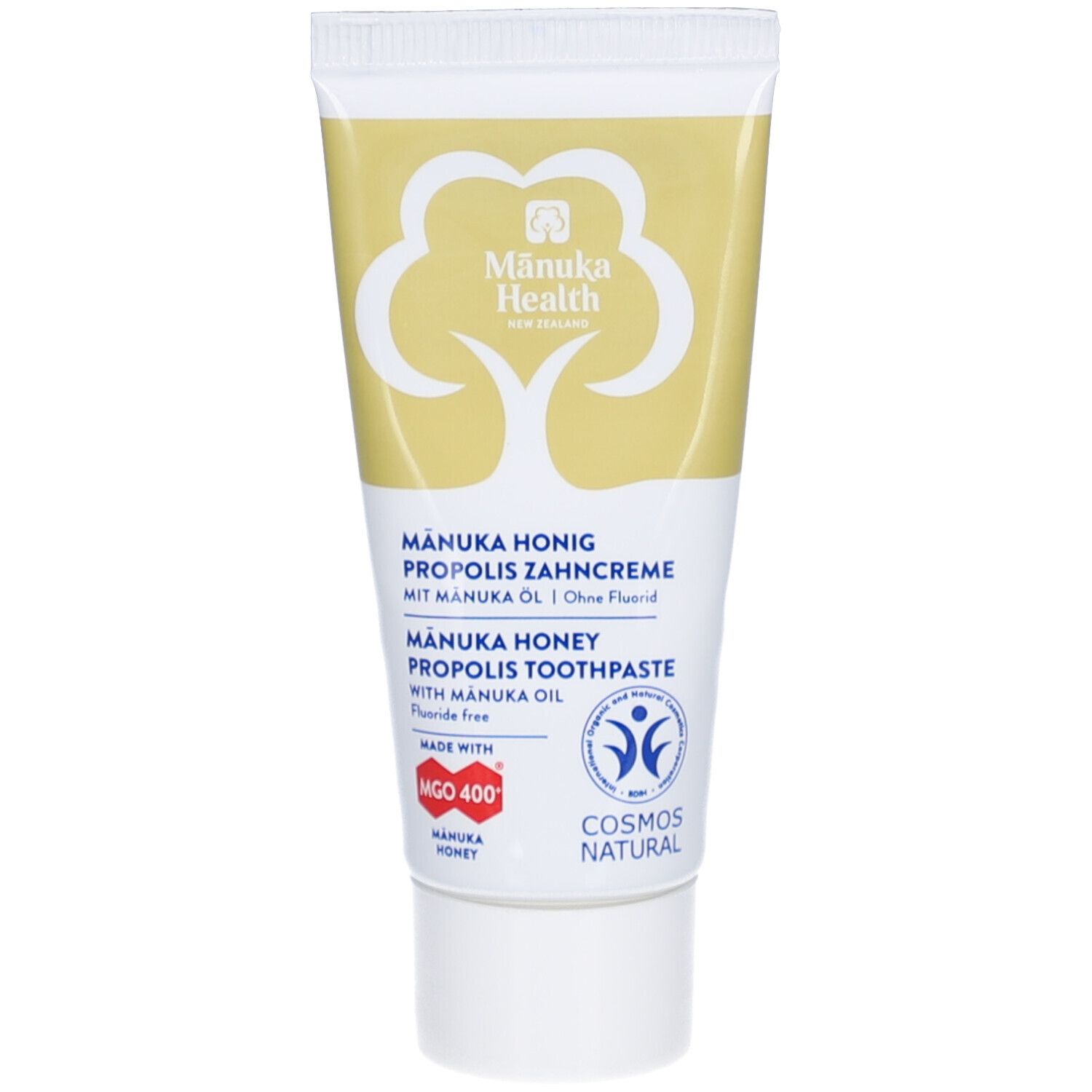 Zahncreme-Tube mit gelbem Deckel und Schriftzug. Enthält Manuka Honig, Propolis und Manuka Öl. Fluoridfrei. Mit Logos und Zertifizierungen.