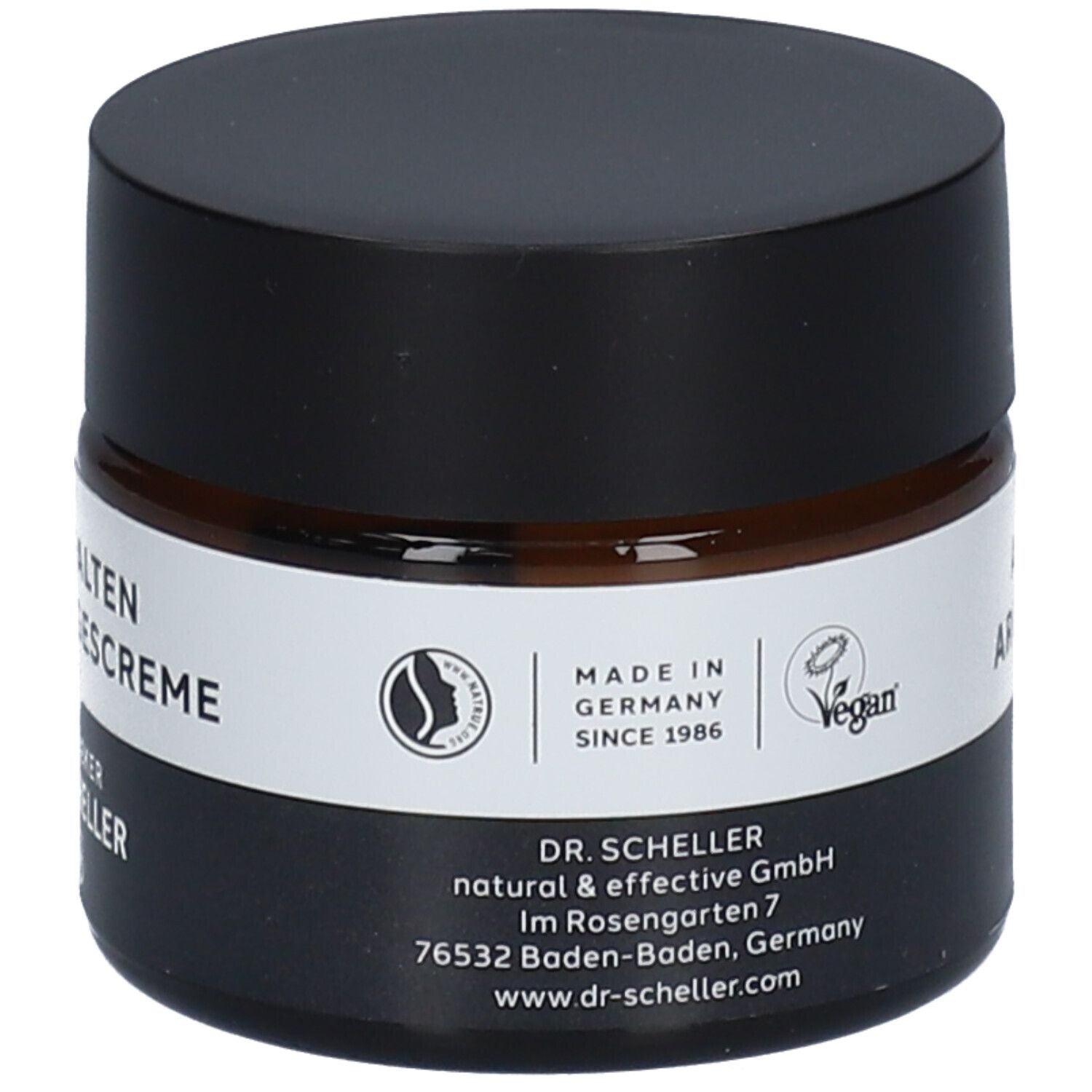 Braunes Creme-Glas mit schwarzem Deckel. Produktname und Logo auf dem Etikett. Vegan-Siegel.