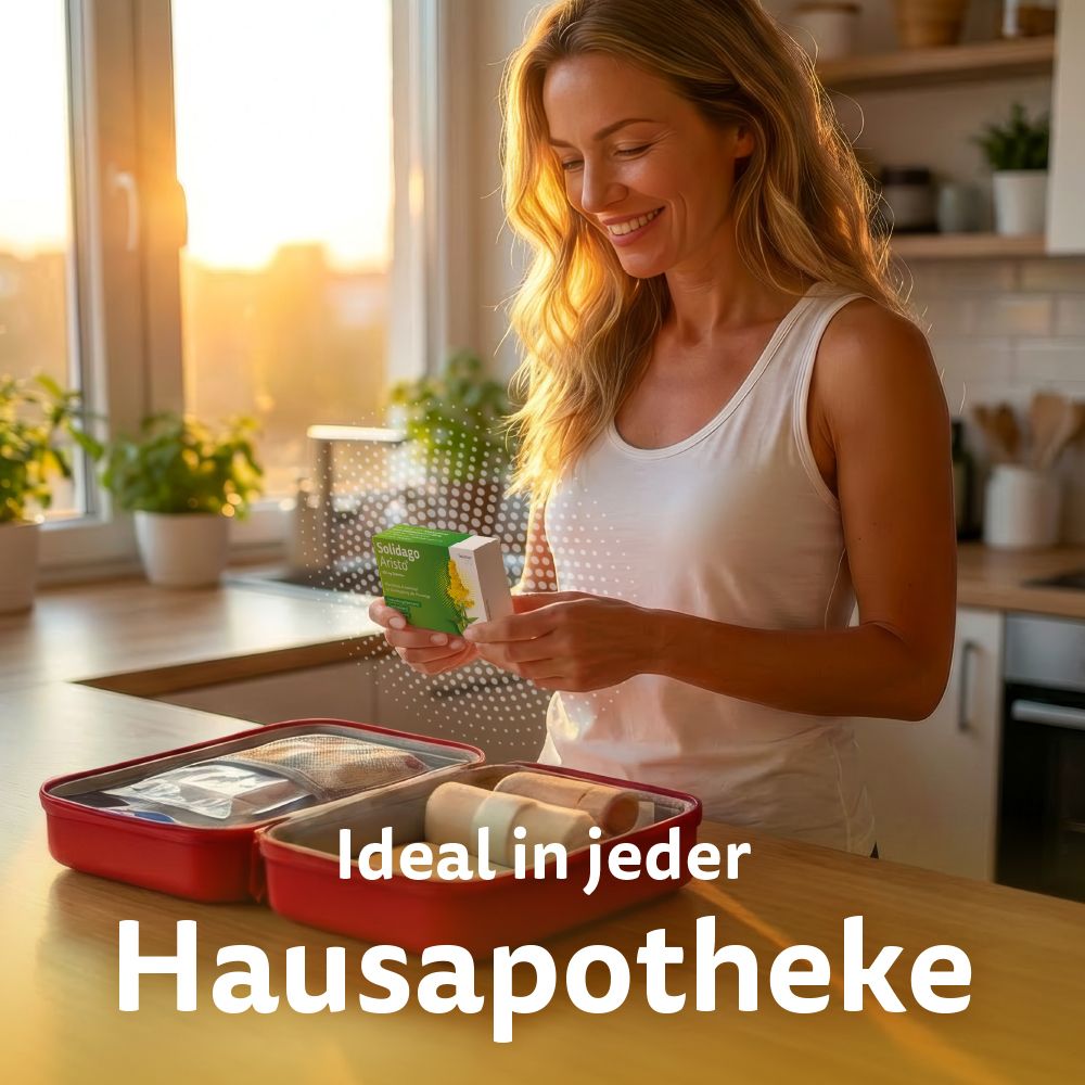 Frau in Küche hält Solidago Aristo, daneben Hausapotheke mit Verbandszeug.