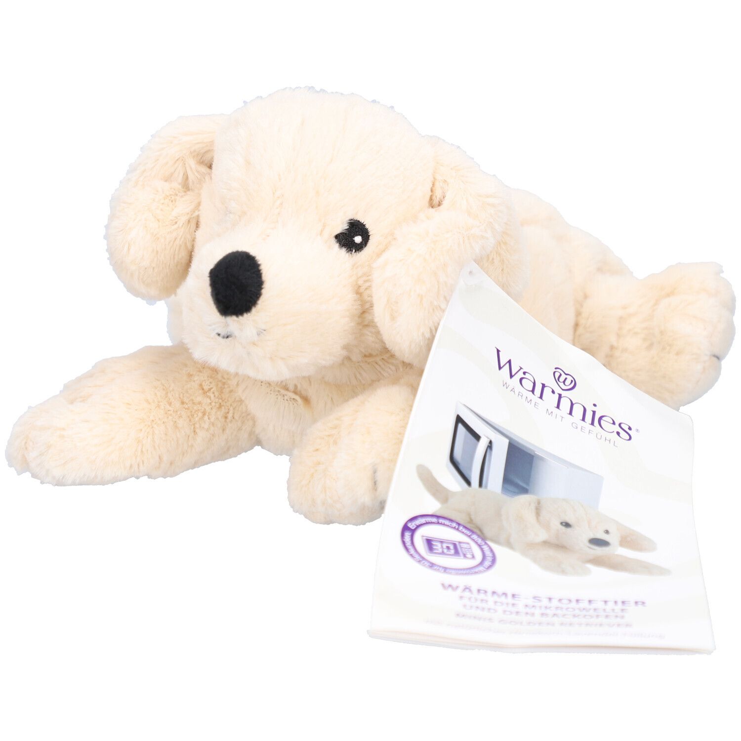 Beiges Stofftier in Retriever-Form. Mit schwarzer Nase und Augen. Liegt neben Produktverpackung mit Logo "Warmies".