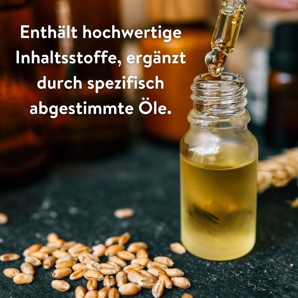 Glasflasche mit Öl und Weizenkörnern. Text: Enthält hochwertige Inhaltsstoffe, ergänzt durch spezifisch abgestimmte Öle.