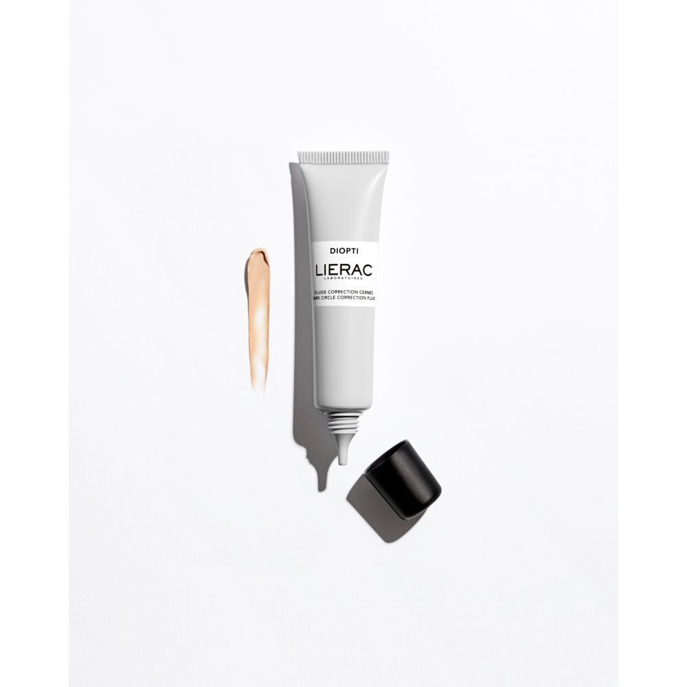 Tubenbehälter, geöffnet, mit Produktprobe daneben. Aufschrift: DIOPTI, LIERAC. Produktname und Text.