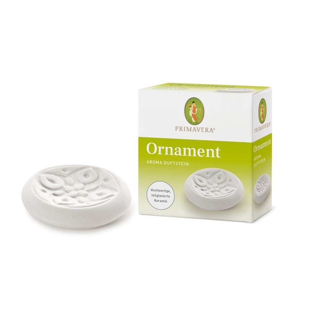 Weißer, ovaler Aroma-Duftstein aus Keramik neben Verpackung. Aufschrift: Primavera, Ornament, Aroma Duftstein.