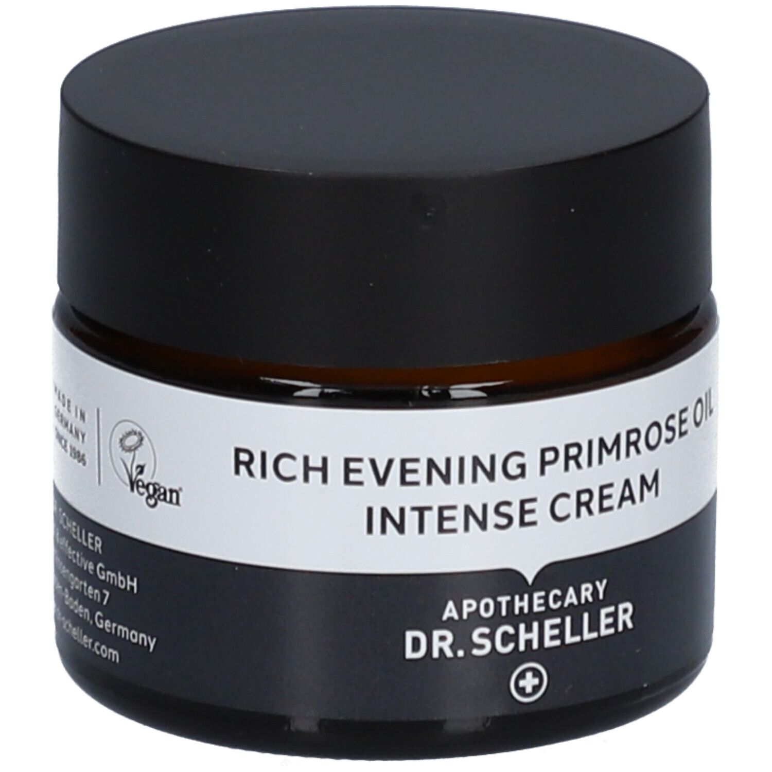 Braunes Creme-Glas mit schwarzem Deckel. Produktname auf weißem Etikett. Vegan-Siegel.