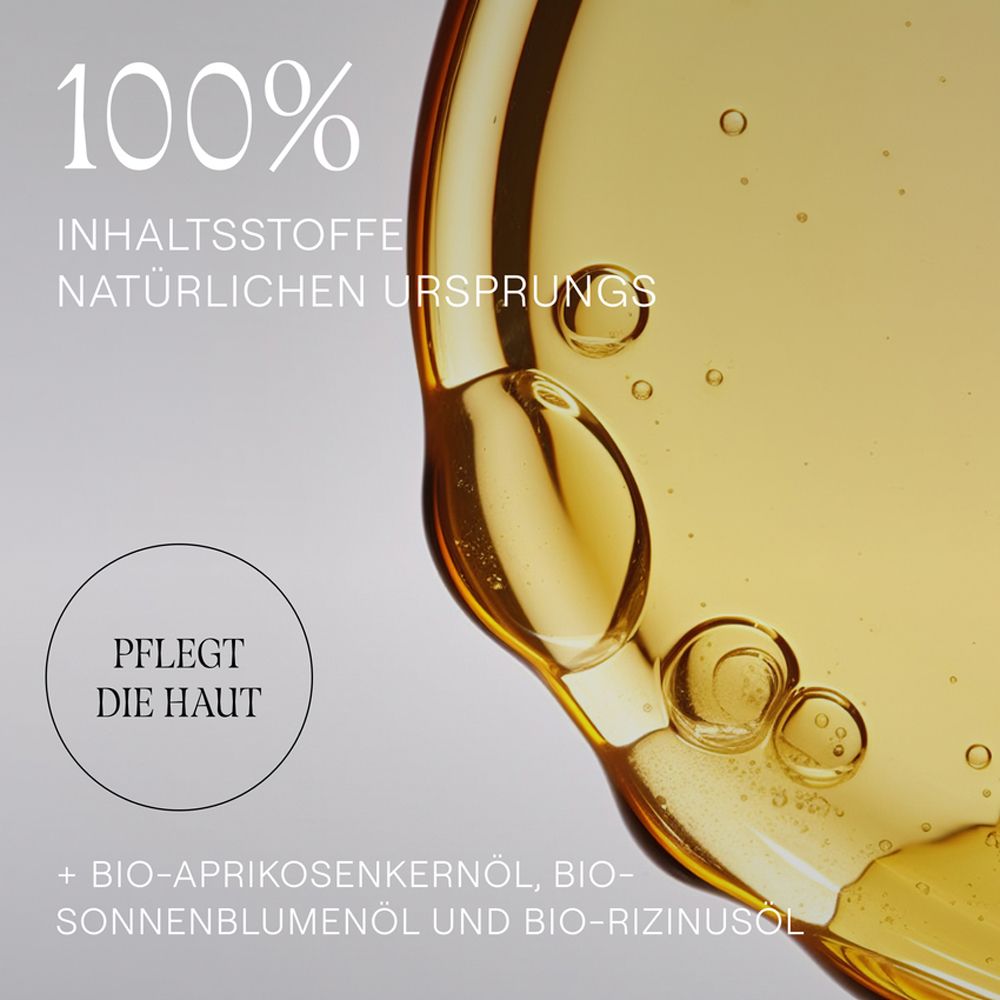 Nahaufnahme von Öl. Text: 100% Inhaltsstoffe natürlichen Ursprungs. Pflegt die Haut. Enthält Bio-Aprikosenkernöl.