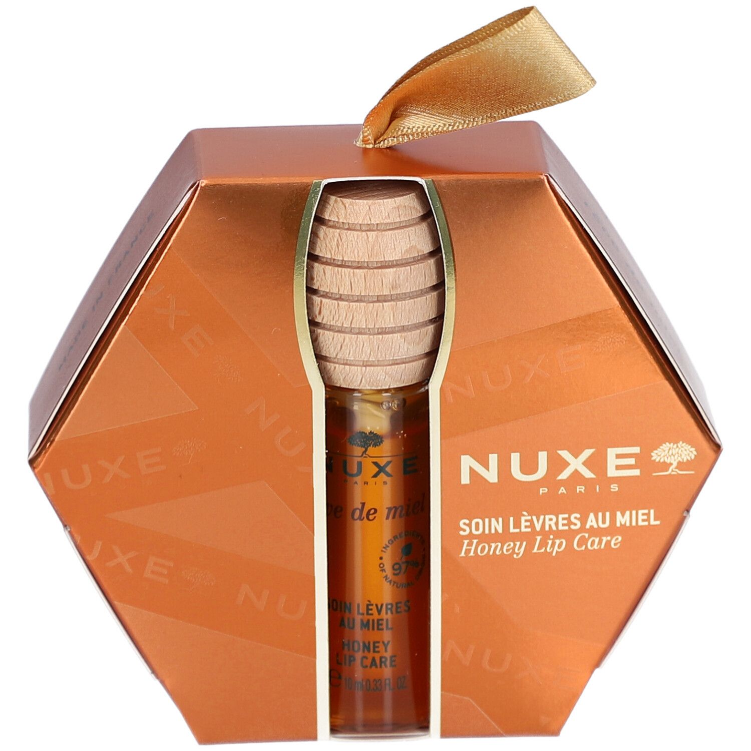 Geschenkset mit Honig-Lippenpflege. Sechseckige, goldfarbene Verpackung. Produkt und Honiglöffel sichtbar. NUXE-Logo.