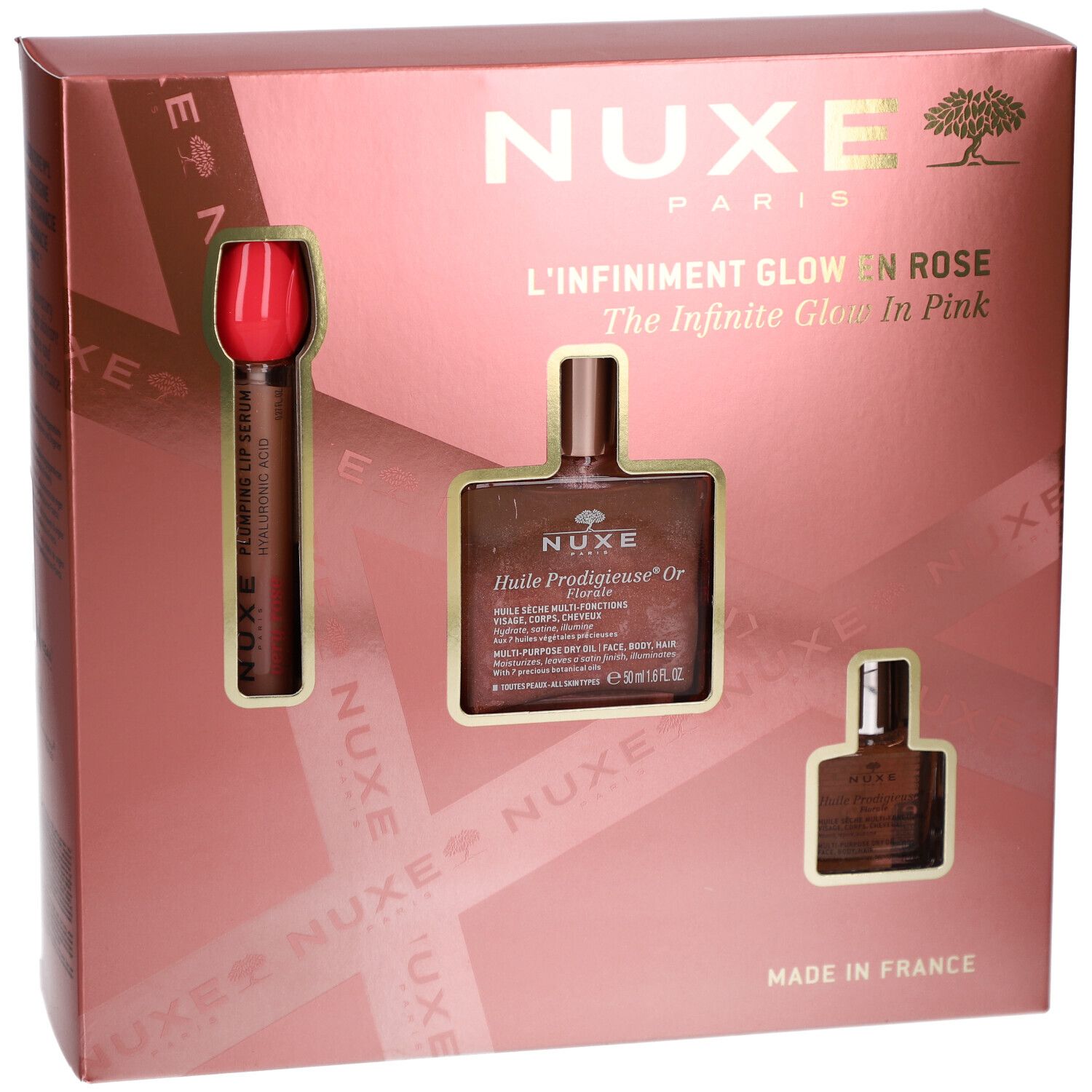 Geschenkset mit drei Produkten in rosa Verpackung. Enthält eine Flasche, eine kleine Flasche und einen Applikator. Marke NUXE.