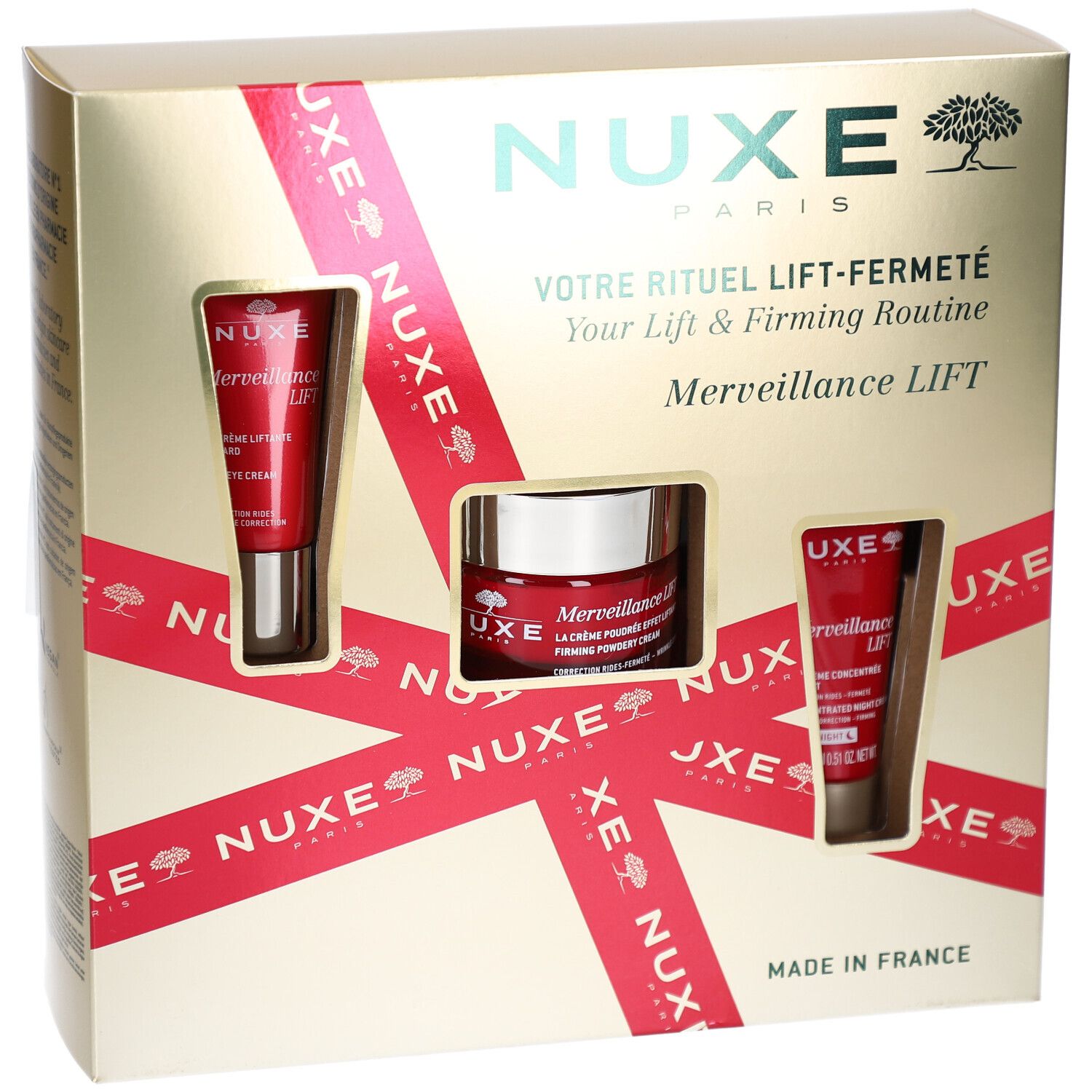 Geschenkbox mit drei Kosmetikprodukten. Goldfarbene Box mit roter Schleife und Produktfenstern. NUXE-Logo und Schriftzug.