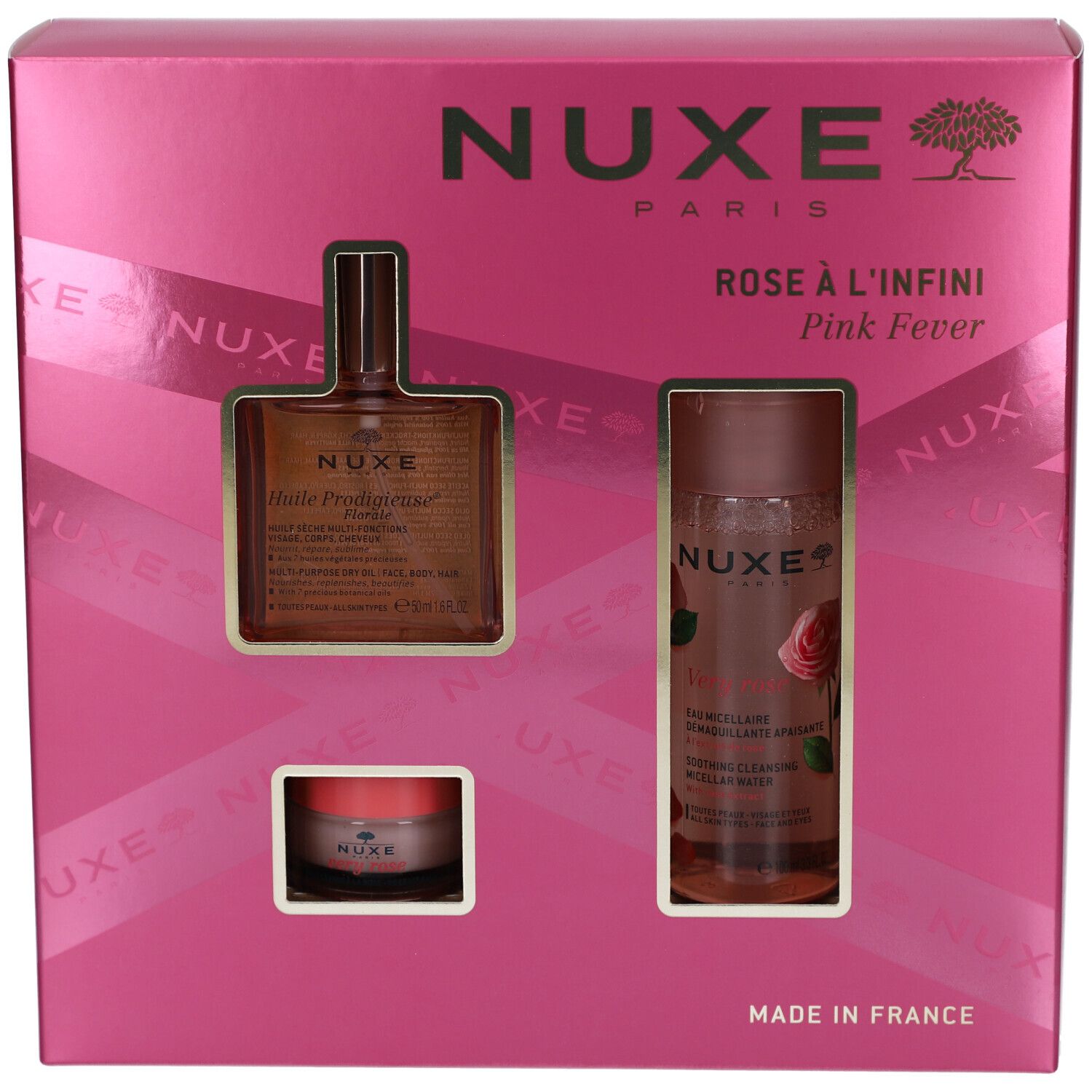 Geöffnete rosa Geschenkbox. Enthält drei Produkte: Ölflasche, Reinigungs-Wasser und Creme. NUXE-Logo sichtbar.