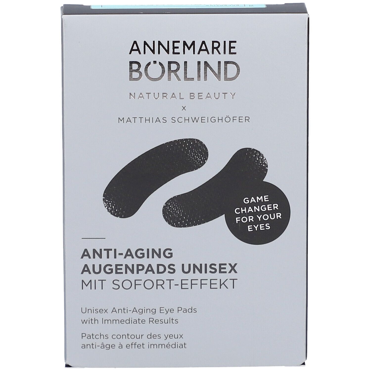 Graue Verpackung mit schwarzen Augenpads. Schriftzug: ANNEMARIE BÖRLIND, Anti-Aging Augenpads Unisex. Mit Sofort-Effekt. Game Changer for your eyes.