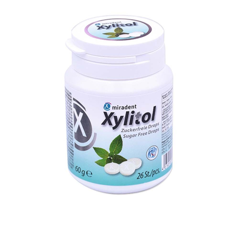 Weiße Dose mit miradent Xylitol Drops. Aufdruck: Xylitol, zuckerfrei, 26 Stück. Mint-Blatt-Illustration.