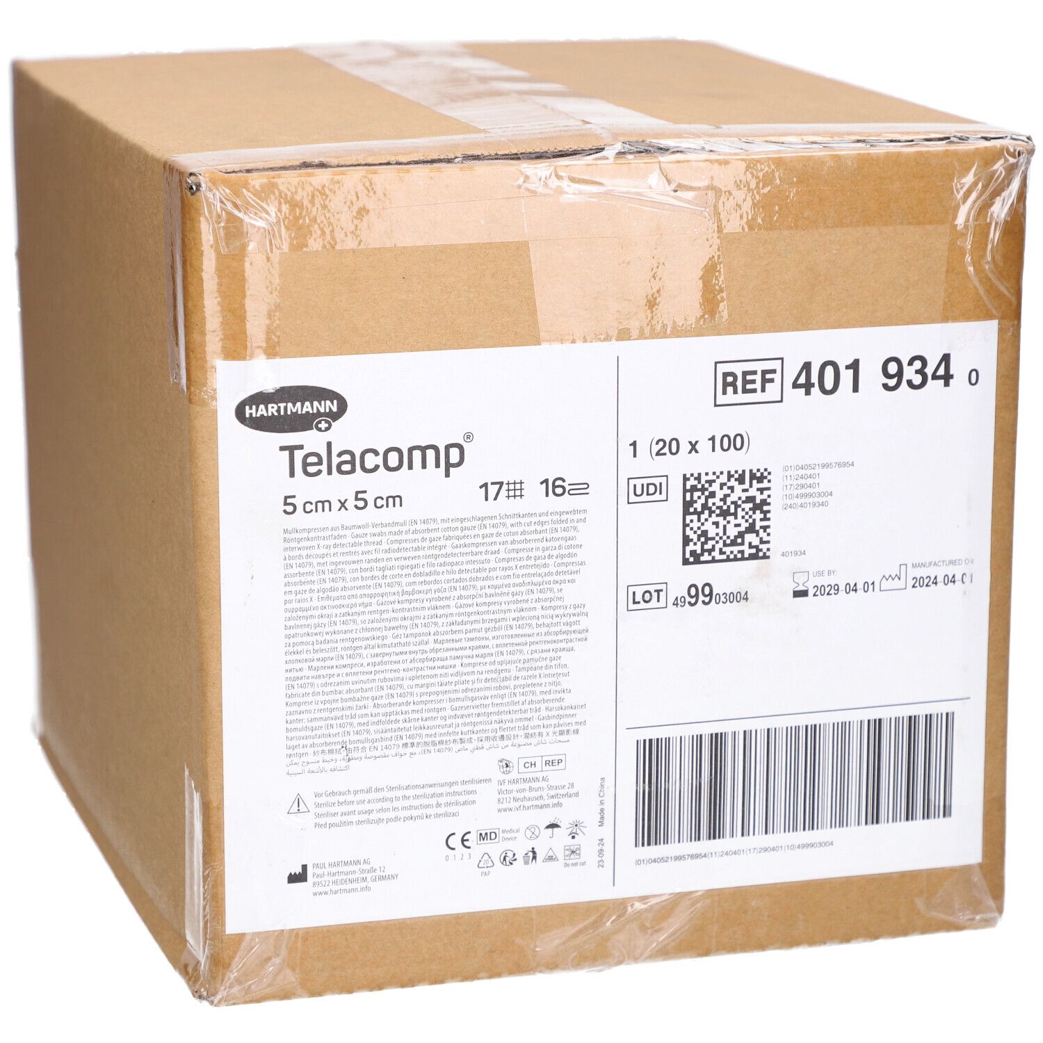 Karton mit Telacomp-Verbandmull. Aufschrift: 5 cm x 5 cm. Enthält Informationen wie REF 401 934, Chargennummer und Verfallsdatum.
