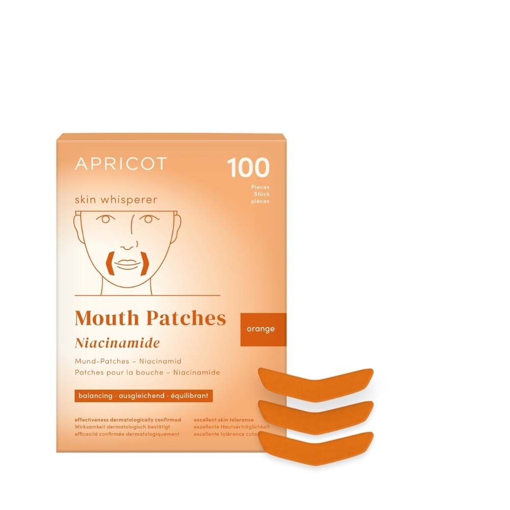 Verpackung mit 100 Mund-Patches. Orangefarbene Patches liegen daneben. Aufdruck: APRICOT, skin whisperer, Mouth Patches Niacinamide.