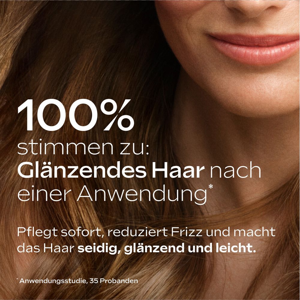 Haar mit Produkt. 100% bestätigen: Glänzendes Haar nach Anwendung. Text und Haare im Fokus.