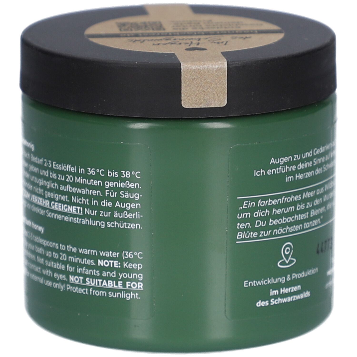 Grünes Glas mit schwarzem Deckel. Text auf Deutsch und Englisch. Hinweise zur Anwendung. Nicht für Kinder.