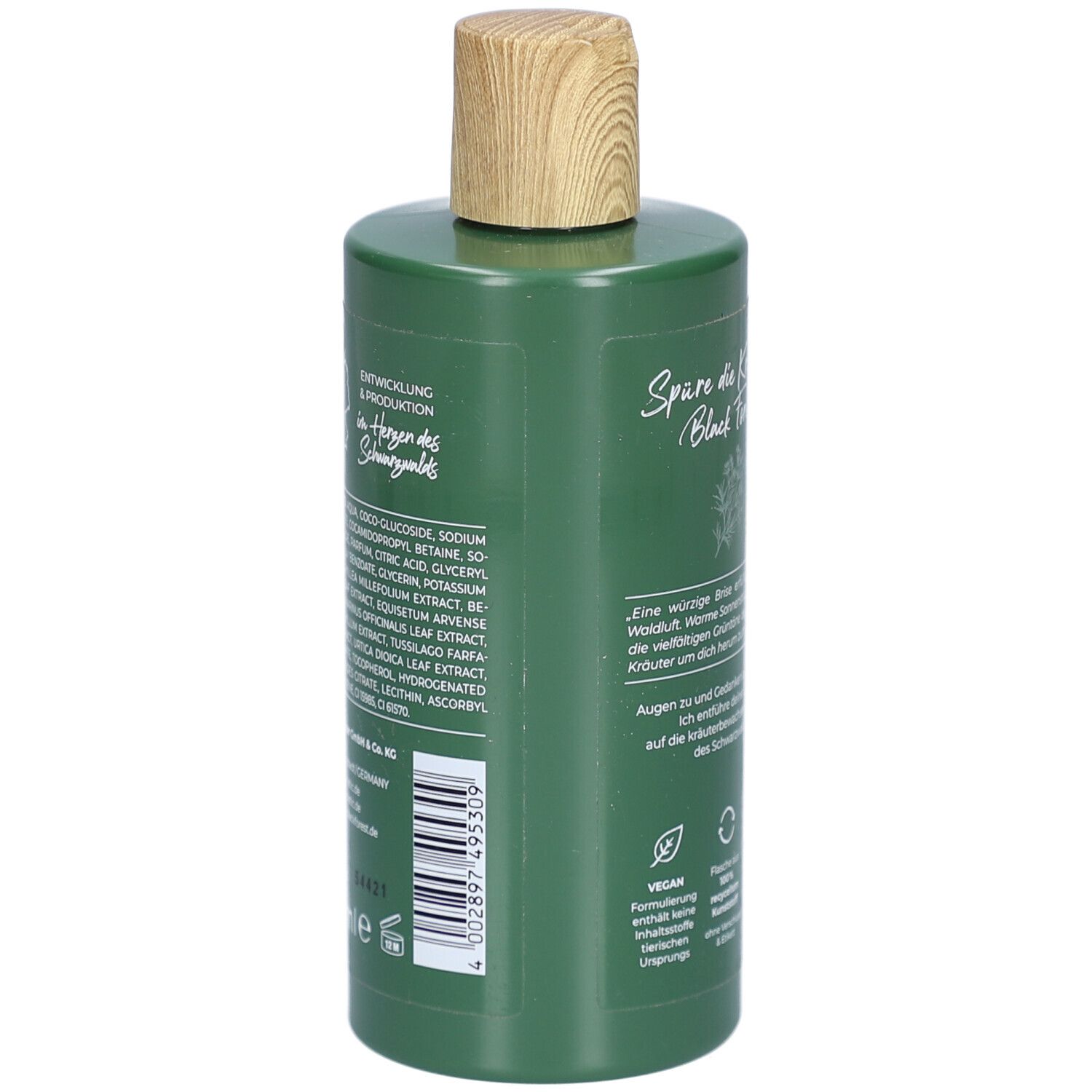 Grüne Flasche mit Holzverschluss. Rückseite mit Text und Inhaltsstoffen. Vegan. Schwarzwälder Duschessenz Waldkräuter.