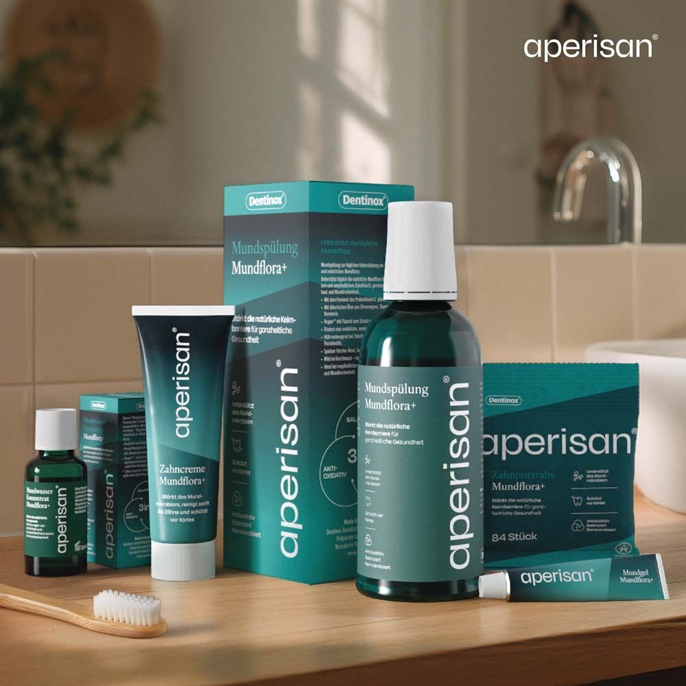 Verschiedene Aperisan Produkte. Flaschen, Tuben und Verpackungen. Holzoberfläche.