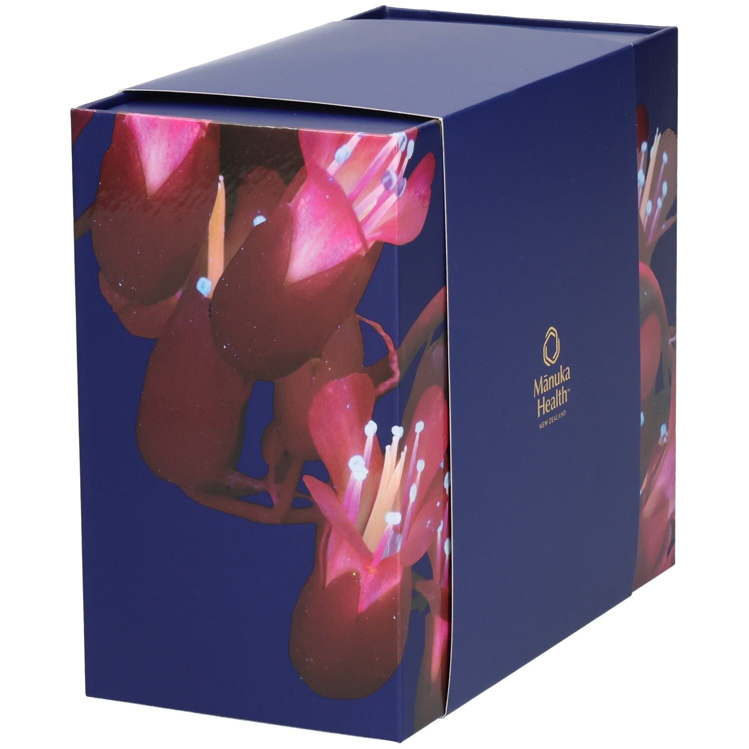 Blau-violette Geschenkbox mit floralem Muster. Logo von Manuka Health New Zealand auf der Seite.