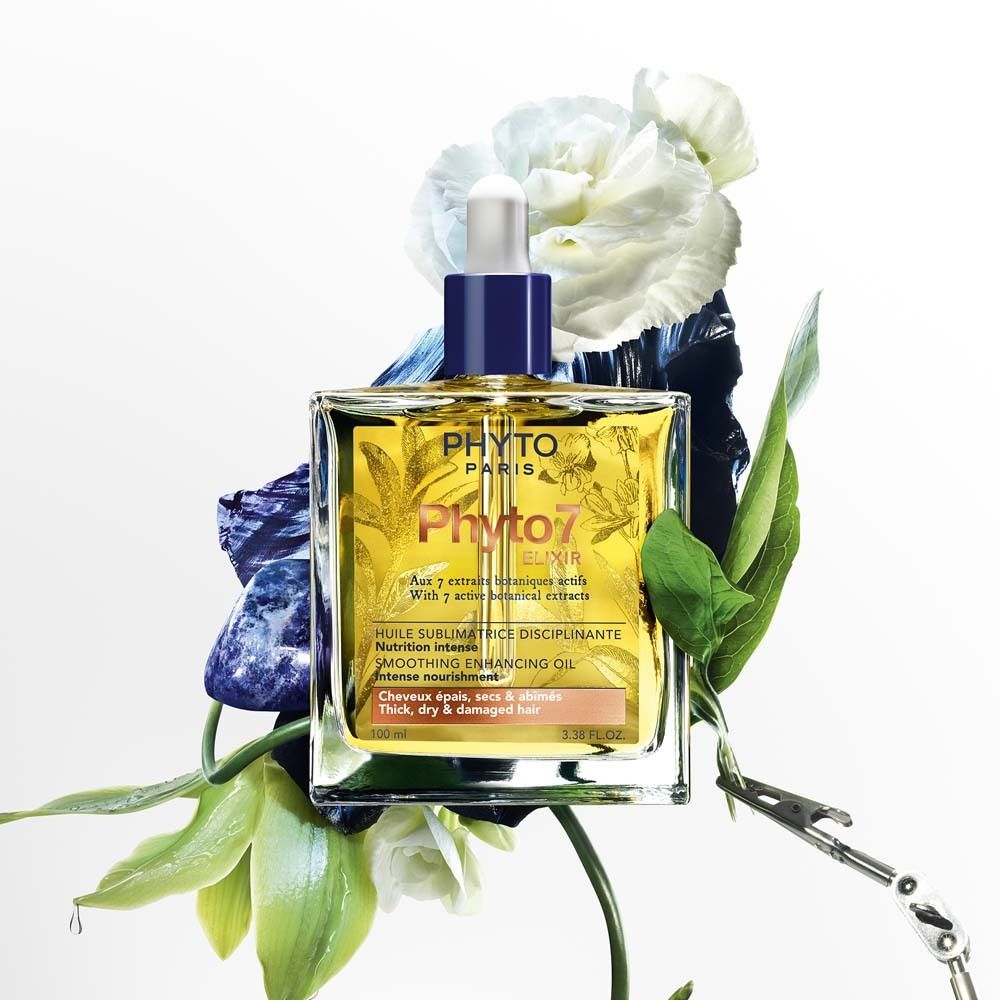 Ölflasche mit Tropfer, umgeben von Blumen und Blättern. Aufschrift: PHYTO PARIS, Phyto 7 Elixir. Für dickes, trockenes und geschädigtes Haar.