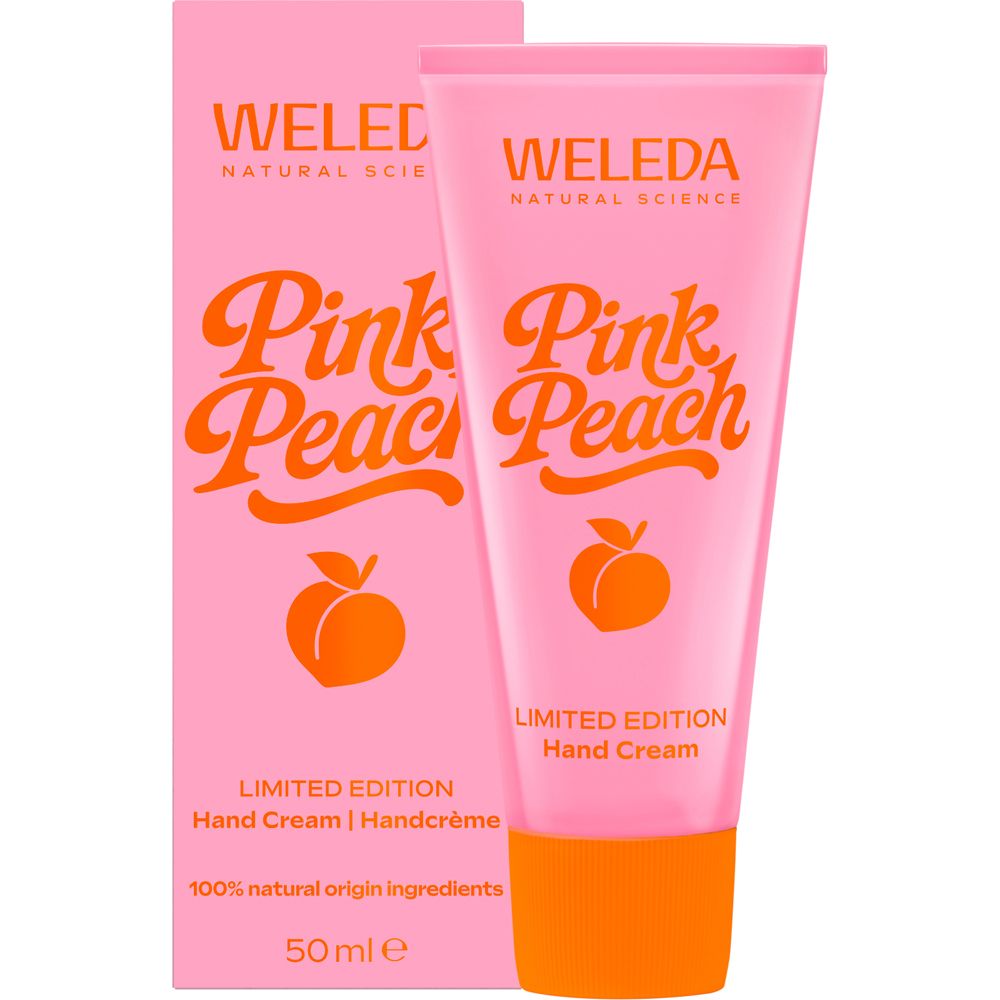 Rosa Handcreme-Tube und Schachtel. Aufschrift: Pink Peach, Limited Edition, Weleda. Orangefarbener Verschluss und Pfirsich-Illustration.