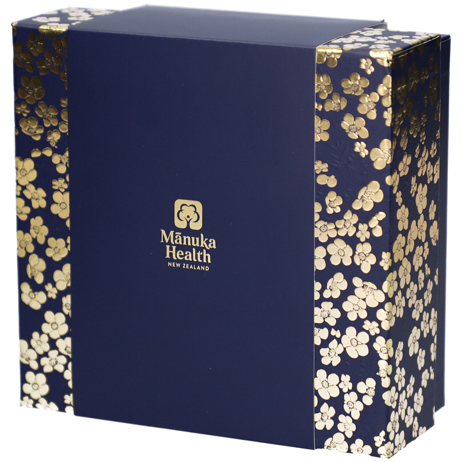 Dunkelblaue Geschenkbox mit goldenen Blütenmustern. Logo: Mānuka Health New Zealand. Rechteckige Form.