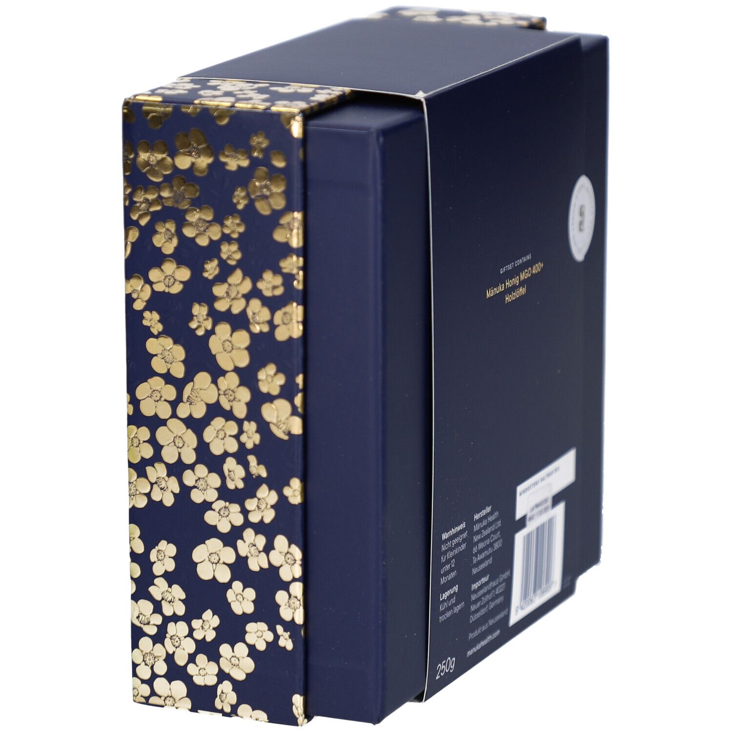 Geschenkbox, Seitenansicht. Dunkelblau mit goldenen Blütenmustern. Text auf der Rückseite sichtbar.