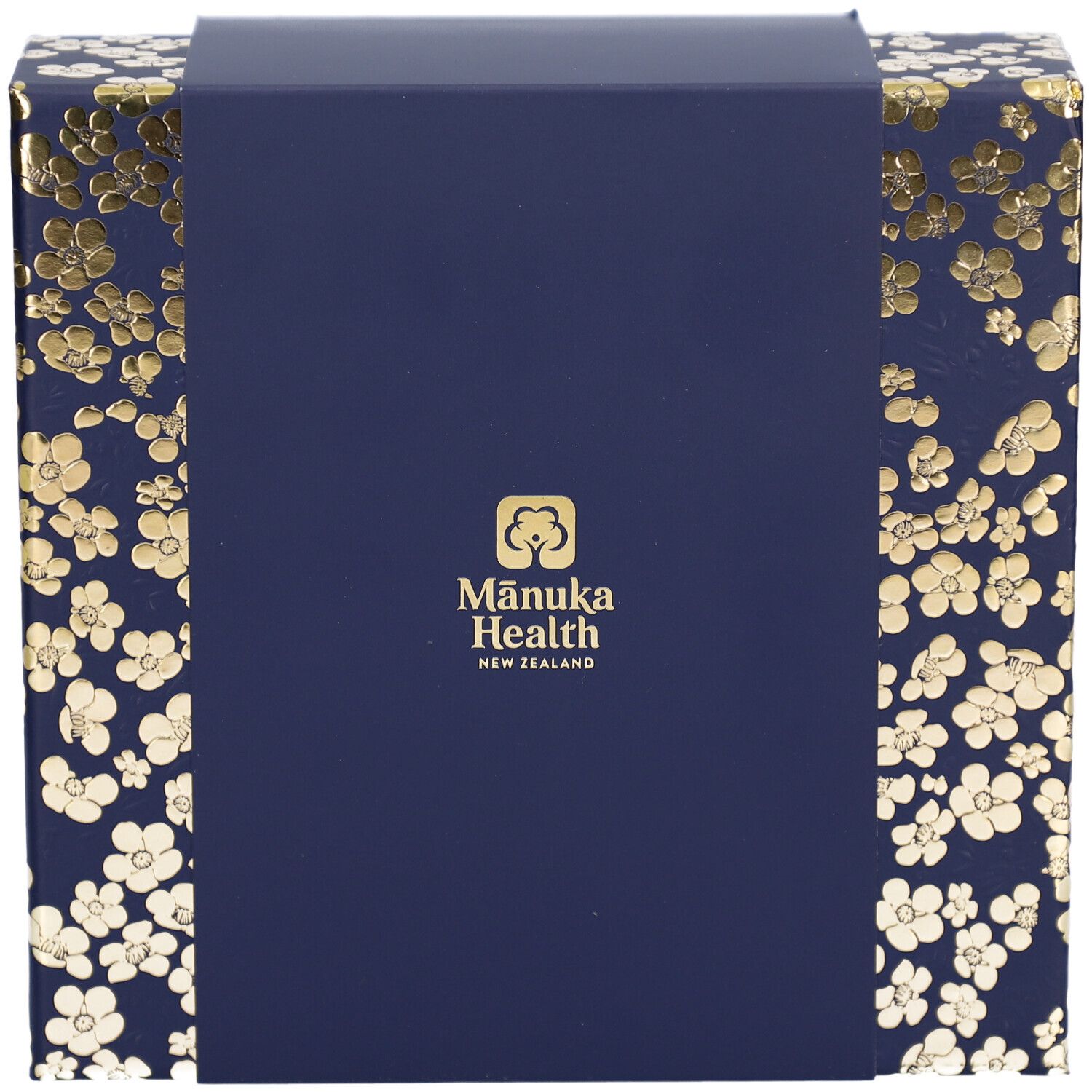 Geschenkbox, Draufsicht. Dunkelblau mit goldenen Blütenmustern. Logo: Mānuka Health New Zealand.