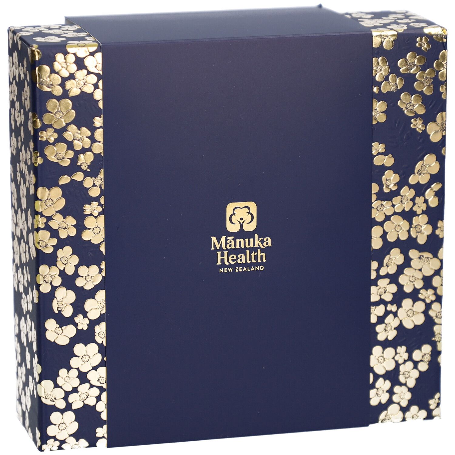 Geschenkbox, Draufsicht. Dunkelblau mit goldenen Blütenmustern. Logo: Mānuka Health New Zealand.